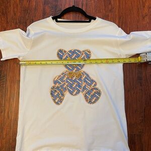 White T-Shirt with Blue Bear Design.